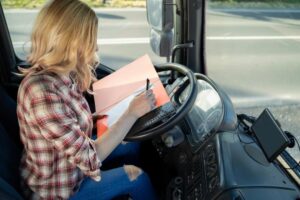 Woman truck driver filling up paper work