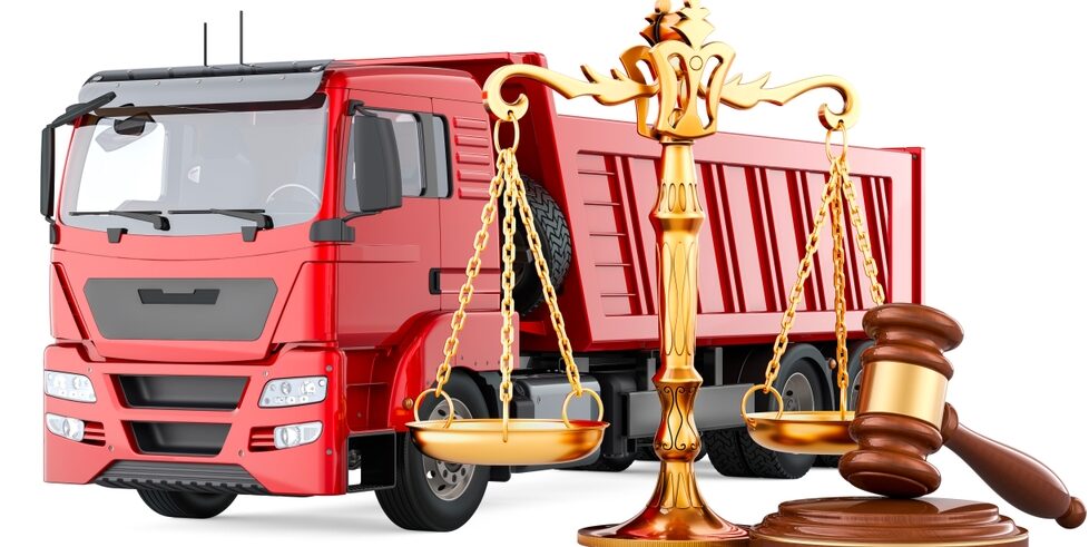 Tipper Truck with wooden gavel and scales of justice, truck accident lawyer concept